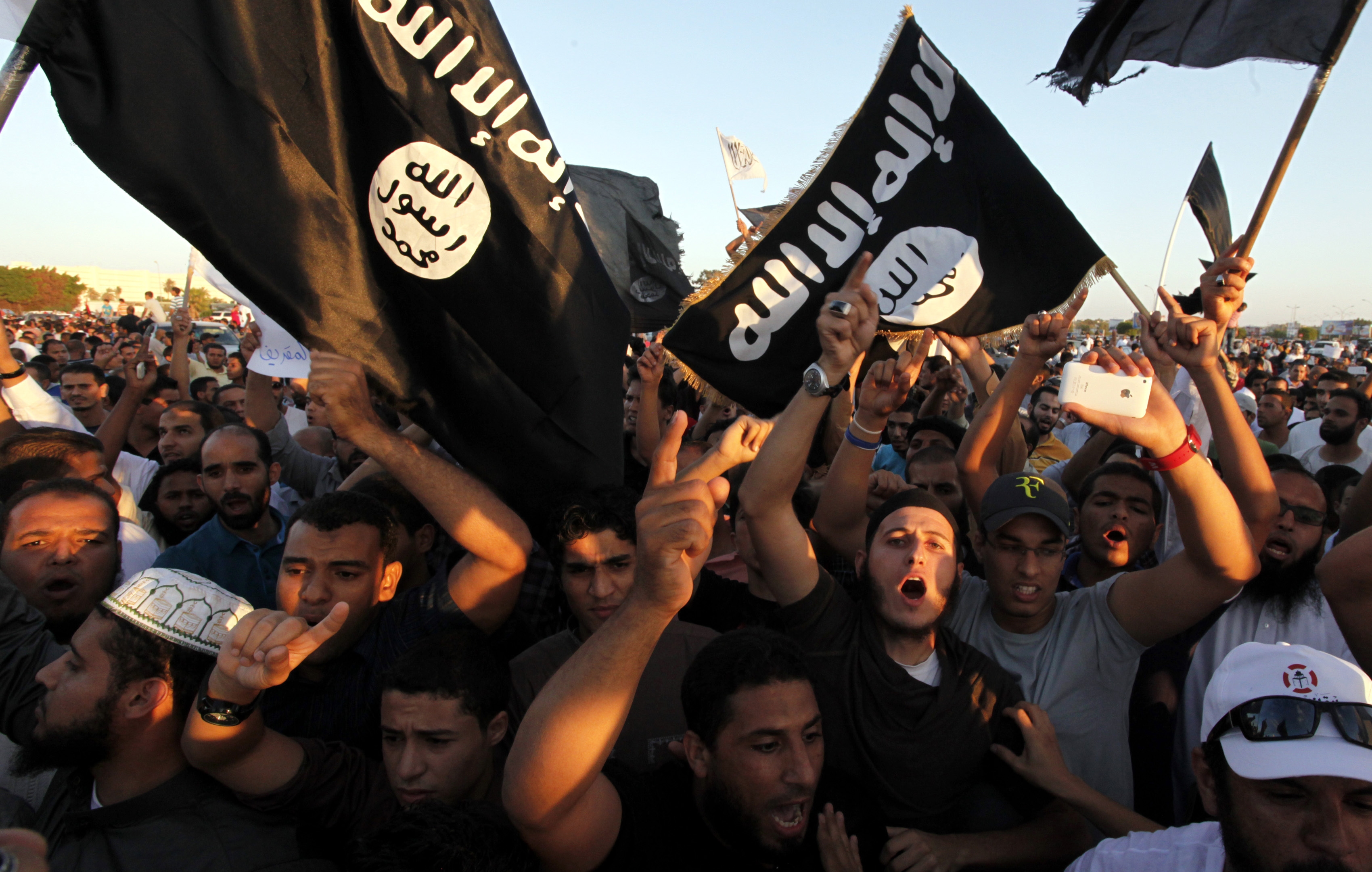 FILE - In this Sept. 21, 2012 file photo, Libyan followers of Ansar al-Shariah Brigades and other Islamic militias, hold a demonstration against a film and a cartoon denigrating the Prophet Muhammad in Benghazi, Libya. On Friday, Oct. 31, 2014, bearded militants gathered at a stage strung with colorful lights in Darna, a Mediterranean coastal city long notorious as Libya